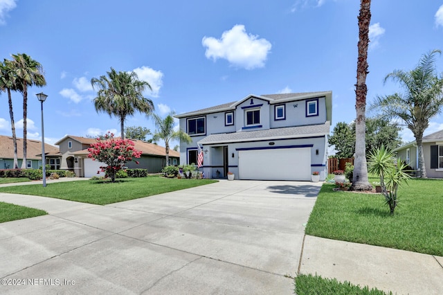 view of front of property with a front yard and a garage