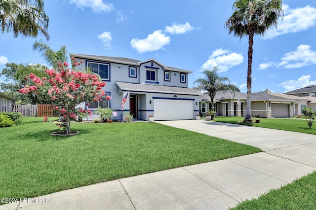 front facade featuring a garage and a front lawn