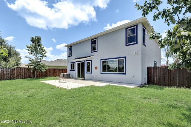 back of property with a patio, cooling unit, and a lawn