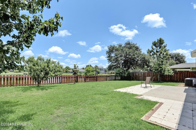 view of yard with a patio area and central air condition unit