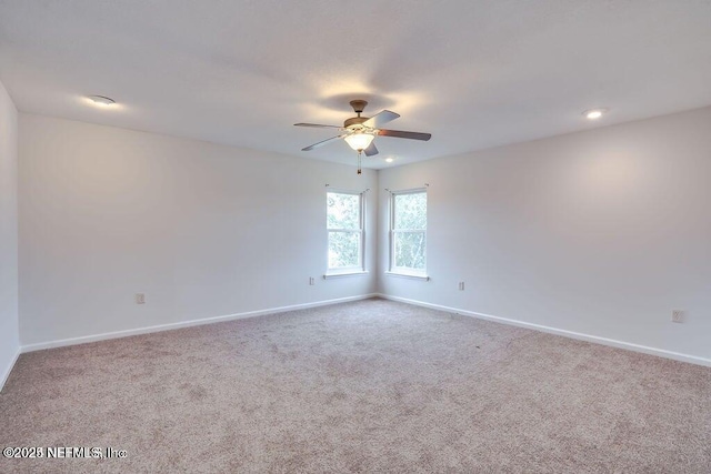 unfurnished room with light carpet and ceiling fan