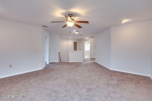 spare room featuring carpet and ceiling fan