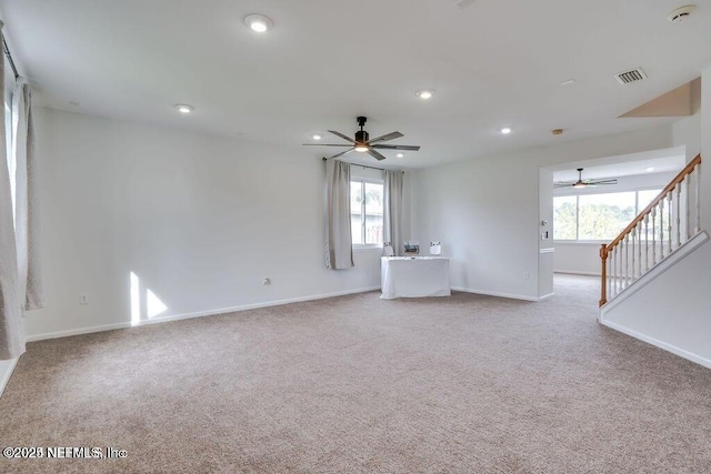 carpeted spare room with ceiling fan