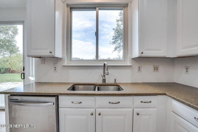 kitchen with white cabinets, tasteful backsplash, dishwasher, and sink