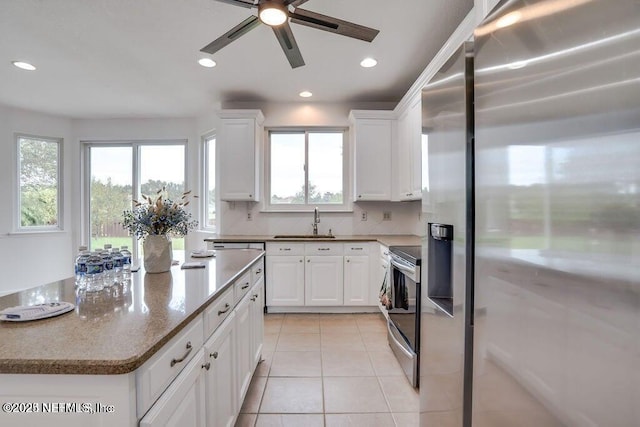 kitchen featuring stone counters, white cabinetry, sink, stainless steel appliances, and tasteful backsplash