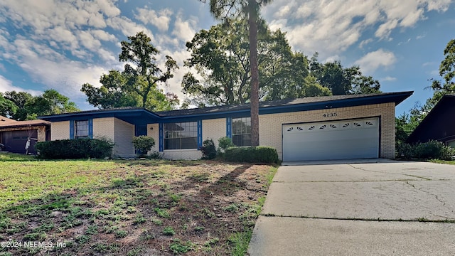 ranch-style home with a garage and a front lawn