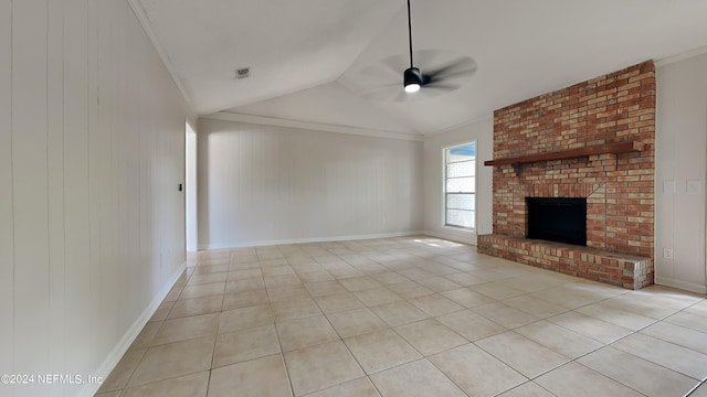 unfurnished living room with ceiling fan, lofted ceiling, ornamental molding, light tile patterned floors, and a brick fireplace