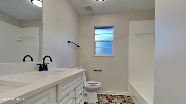 full bathroom with tub / shower combination, vanity, toilet, and a textured ceiling