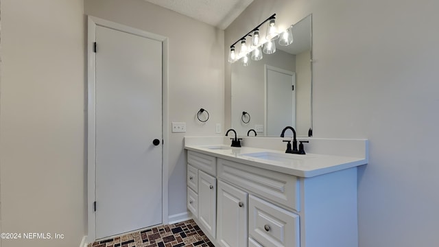 bathroom featuring vanity and a textured ceiling