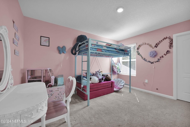 carpeted bedroom featuring a textured ceiling