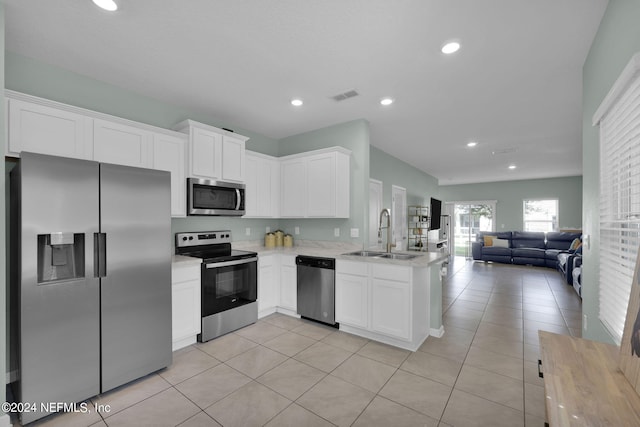 kitchen featuring kitchen peninsula, white cabinets, appliances with stainless steel finishes, and sink