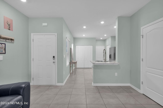 tiled foyer with sink