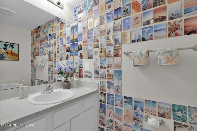 bathroom with vanity and a textured ceiling