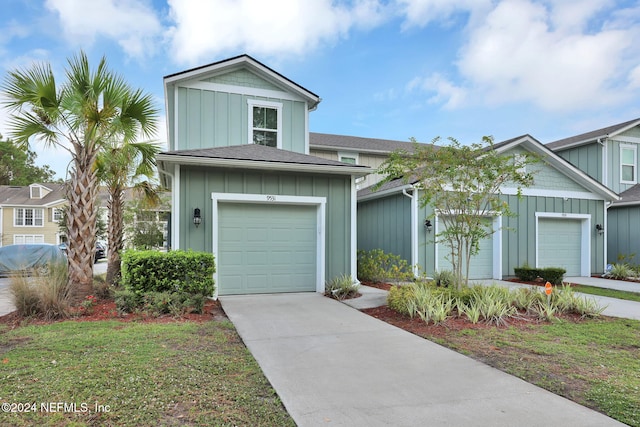 view of front of house with a garage and a front yard