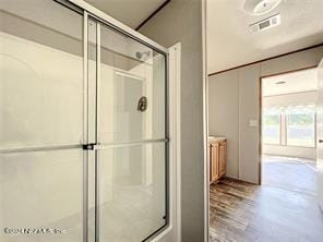 bathroom with walk in shower and hardwood / wood-style flooring