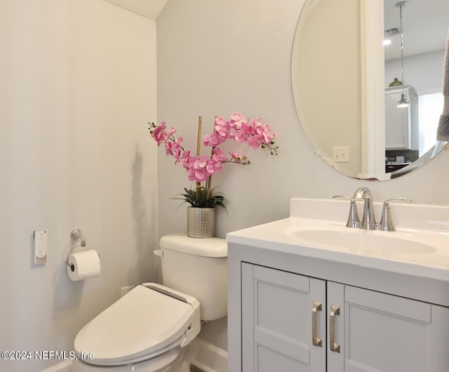 bathroom with vanity and toilet