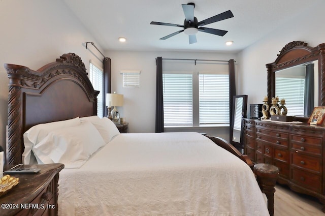 bedroom with ceiling fan and multiple windows