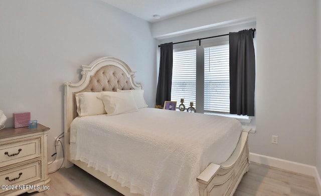 bedroom with light hardwood / wood-style flooring