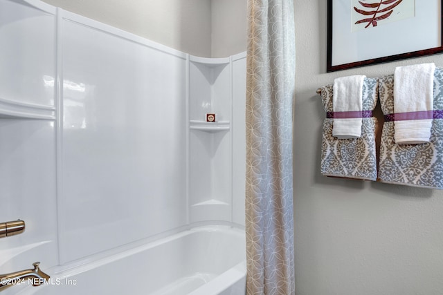 bathroom with shower / bath combination with curtain