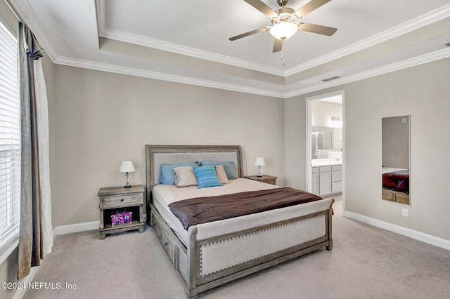 carpeted bedroom featuring ornamental molding, ceiling fan, a tray ceiling, and connected bathroom