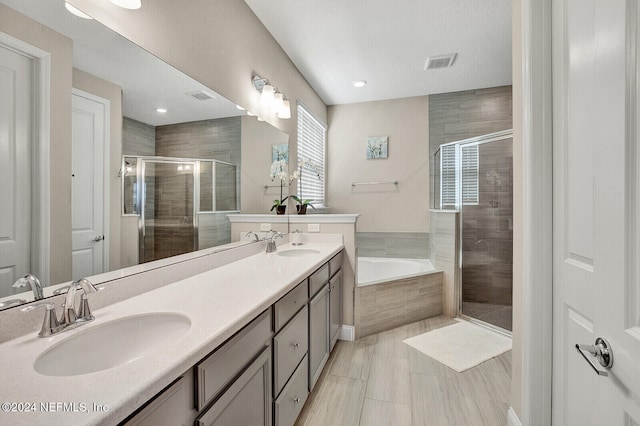 bathroom with vanity, shower with separate bathtub, and tile patterned flooring