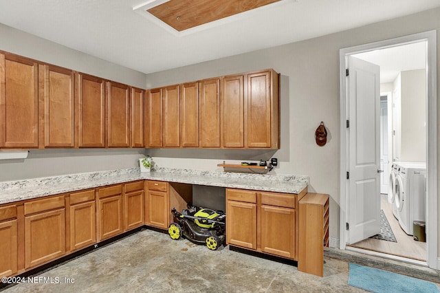 interior space featuring washer and dryer and light stone counters