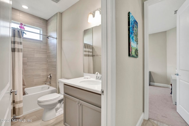 full bathroom featuring wood-type flooring, vanity, toilet, and shower / tub combo