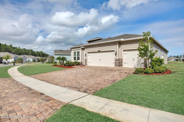 view of front of property featuring a garage and a front yard