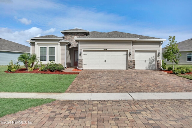 view of front of property with a garage and a front lawn