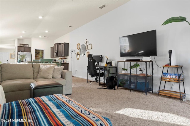 carpeted living room with lofted ceiling