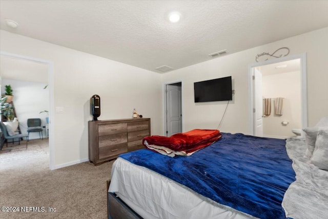 carpeted bedroom featuring a textured ceiling