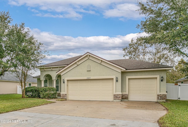 view of front facade with a garage and a front yard