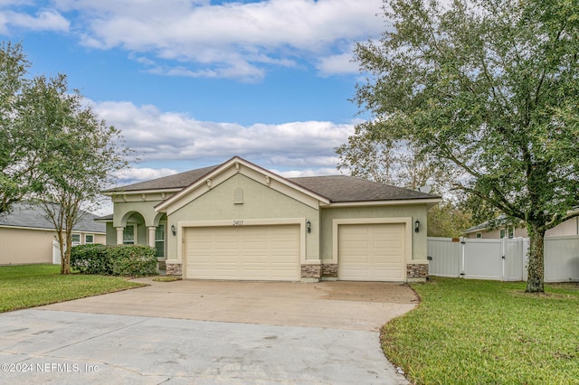 view of front of house featuring a garage and a front lawn