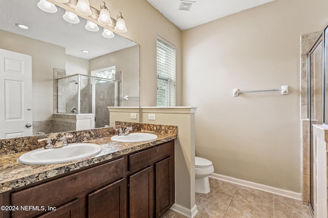 bathroom with vanity, tile patterned floors, toilet, and an enclosed shower