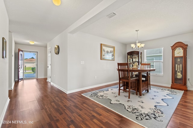 dining room with a healthy amount of sunlight, an inviting chandelier, and dark hardwood / wood-style floors