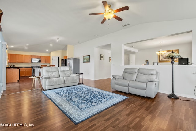 living room featuring vaulted ceiling, dark hardwood / wood-style floors, and ceiling fan with notable chandelier