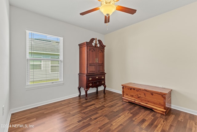 misc room with dark wood-type flooring and ceiling fan