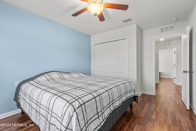 bedroom with ceiling fan, a closet, and dark hardwood / wood-style flooring