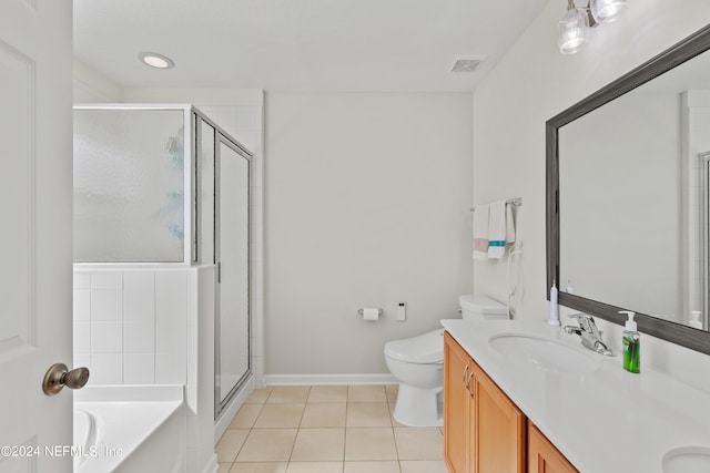 full bathroom featuring toilet, plus walk in shower, vanity, and tile patterned floors