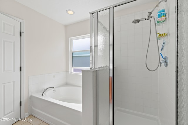 bathroom featuring tile patterned flooring and shower with separate bathtub