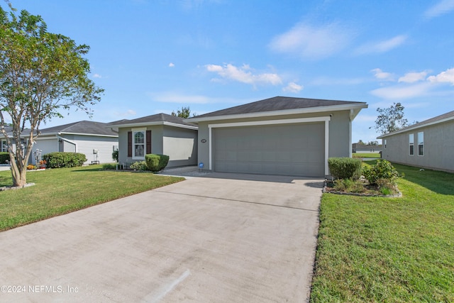 ranch-style house with a garage and a front lawn