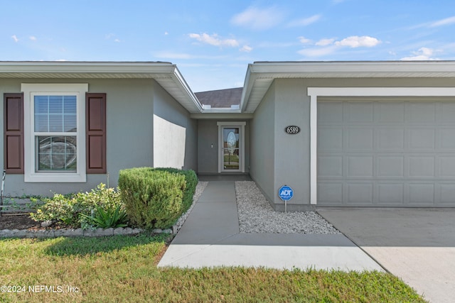 view of exterior entry with a garage