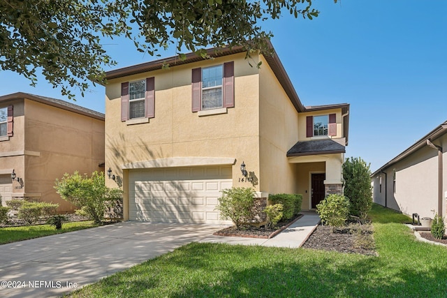 view of front of house with a front yard and a garage