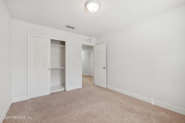 unfurnished bedroom with a closet and carpet