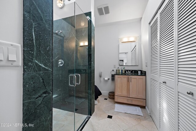 bathroom with vanity, tile patterned flooring, and a shower with door