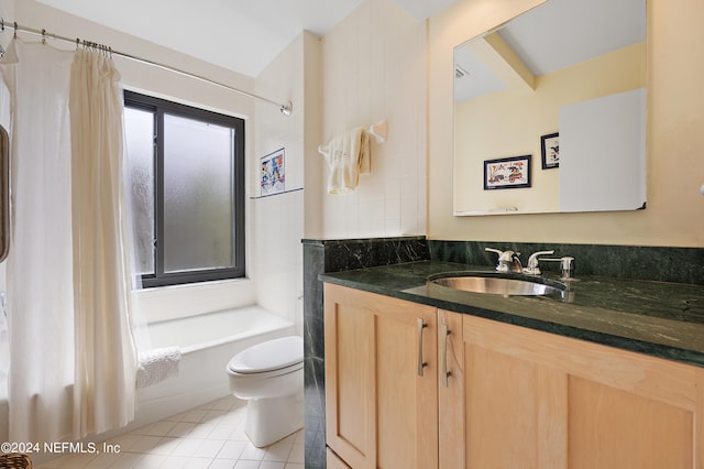 full bathroom with shower / bath combo with shower curtain, tile patterned floors, vanity, and toilet