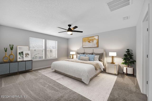 bedroom featuring ceiling fan, carpet floors, and a textured ceiling