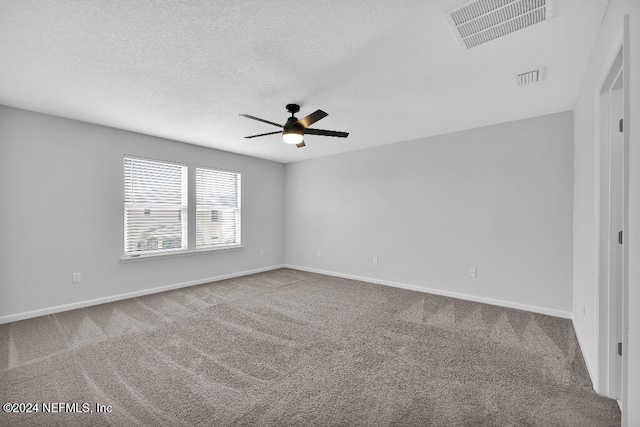 carpeted spare room with a textured ceiling and ceiling fan