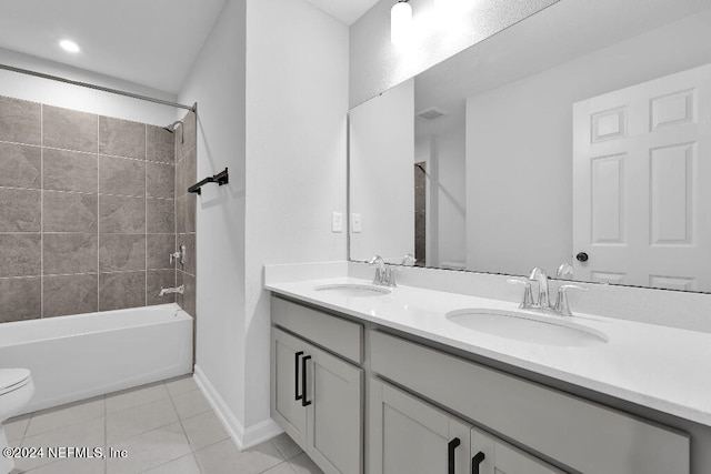 full bathroom with tile patterned floors, vanity, toilet, and tiled shower / bath