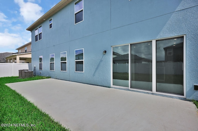 back of house with central air condition unit and a patio area